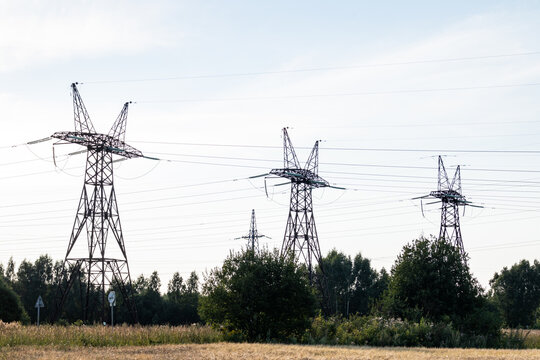Power transmission towers and lines across rural landscape