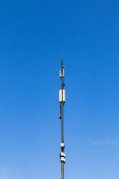 Cellular antenna tower against clear blue sky background