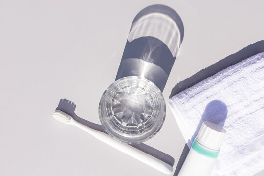 Toothbrush and toothpaste with crystal shadow on white background