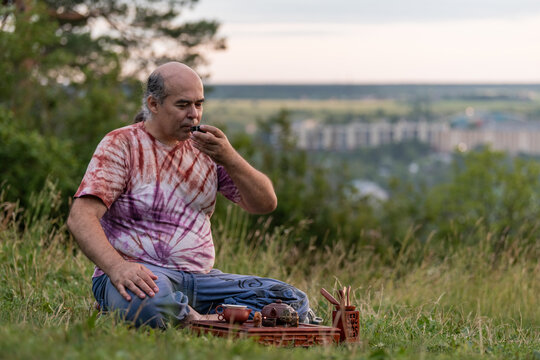 Man practice tea ritual outdoors for holistic health