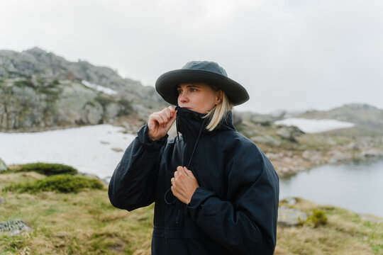 A woman hiker in a rain jacket