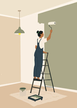 Woman painting wall in new home interior renovation
