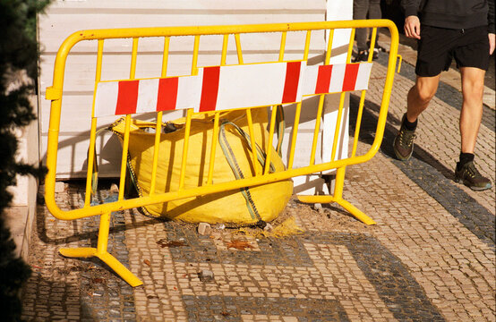 Pedestrian Passes Yellow Barrier