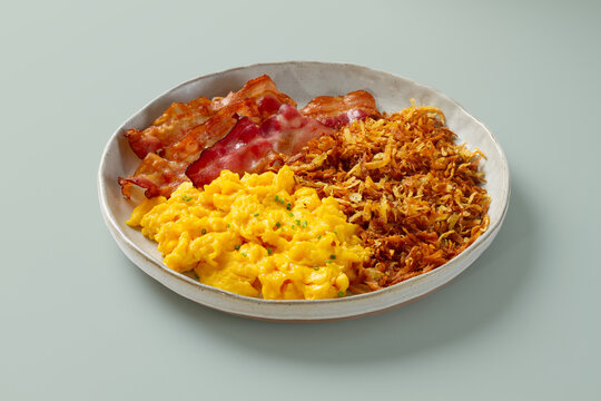 Bacon, scrambled eggs and hash brown breakfast plate