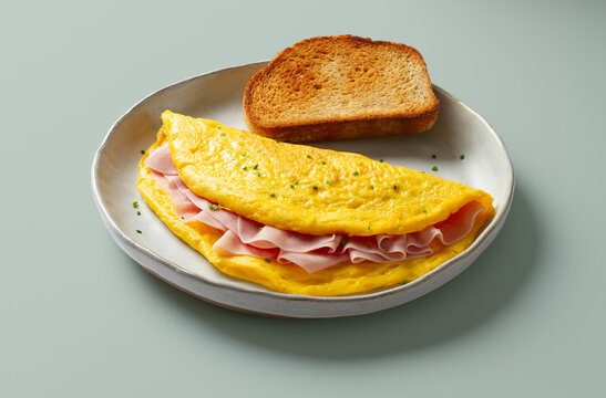 Ham omelette with toast on a ceramic plate