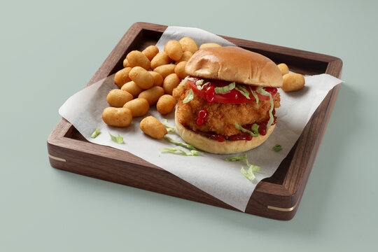 Crispy chicken sandwich with tater tots and ketchup