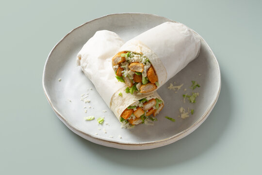 Grilled chicken caesar wrap on ceramic plate