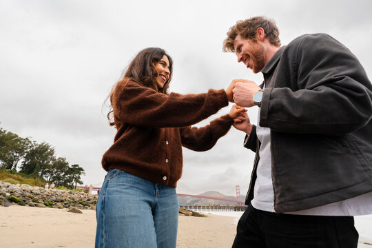 couple holding hands together playful date