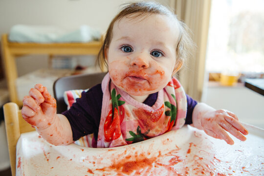 Baby with messy face looking at camera