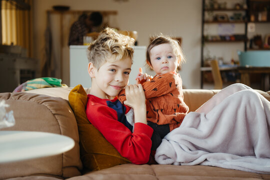 Lifestyle portrait of big brother and baby sister