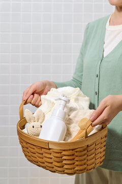 Woman holding a basket of baby essentials