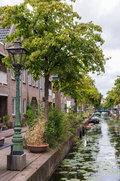 Green canal street with boats and trees in Leiden's Little Venice Netherlands