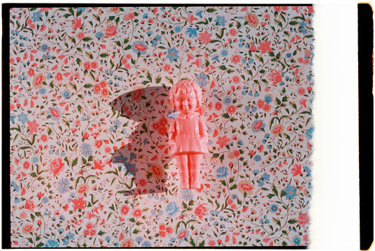 film light leak beside a pink plastic doll, 35mm film