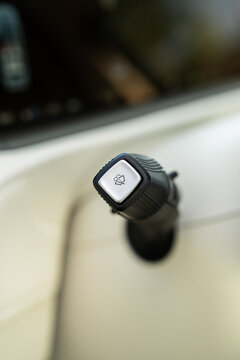 Electric car windshield washer control knob close-up