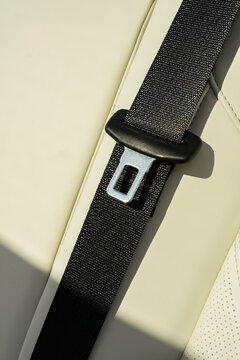 Electric car seat belt detail with beige leather interior