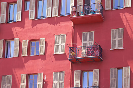 Red facade with balconies in historic Nice city center