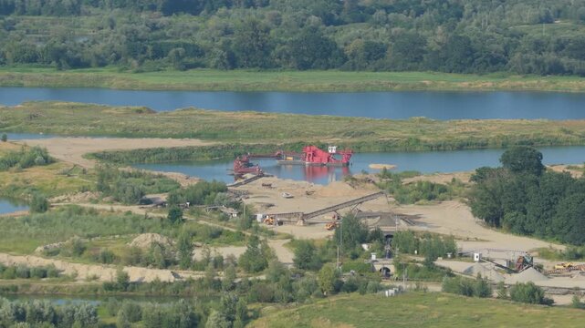 Sand and gravel quarry dredging on a riverbank