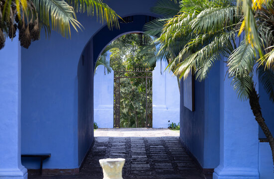 Blue colonial archway with palm trees in Cuernavaca