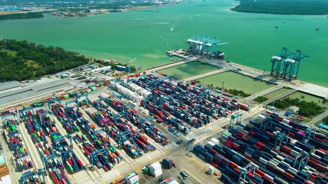 Aerial view of a container port in Klang, Selangor, with cargo terminals, cranes and shipping facilities along the Strait of Malacca.
