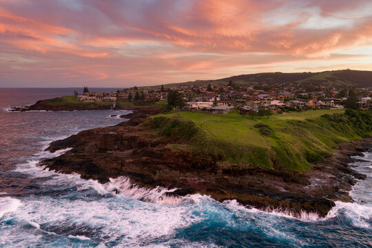 Sunset over Kendalls Beach and Kiama coastal headland