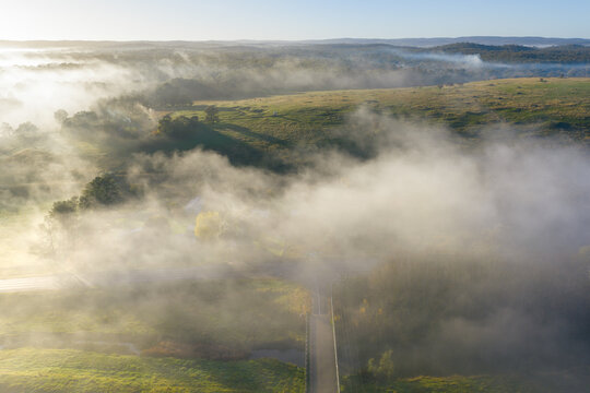 Misty sunrise over rolling countryside near Yapeen, Victoria