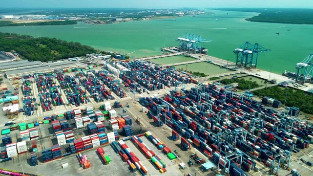 Aerial view of a container port in Klang, Selangor, with cargo terminals, cranes and shipping facilities along the Strait of Malacca.