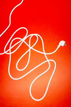 White power cord with plug on red background
