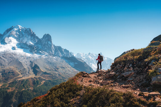 Solo Hiker Standing on Mountain Ridge Looking at Mont Blanc Massif in Chamonix French Alps