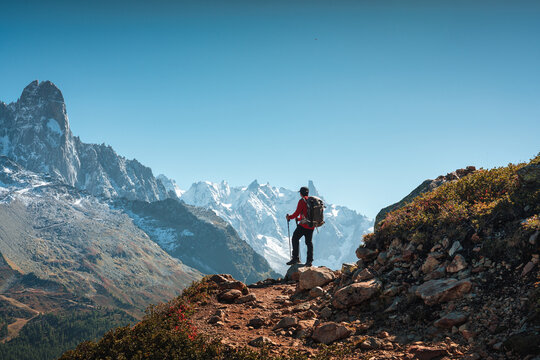 Solo Hiker Standing on Mountain Ridge Looking at Mont Blanc Massif in Chamonix French Alps