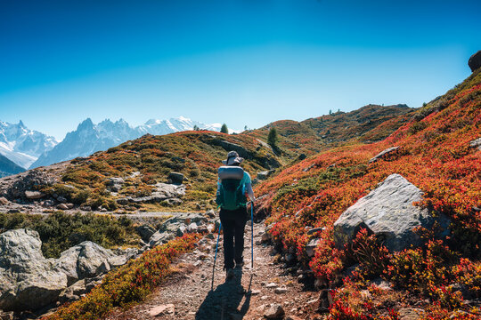 Solo Female Hiker Standing on Mountain Ridge Looking at Mont Blanc Massif in Chamonix French Alps