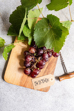 Red grape cluster with vine leaf and wine tag
