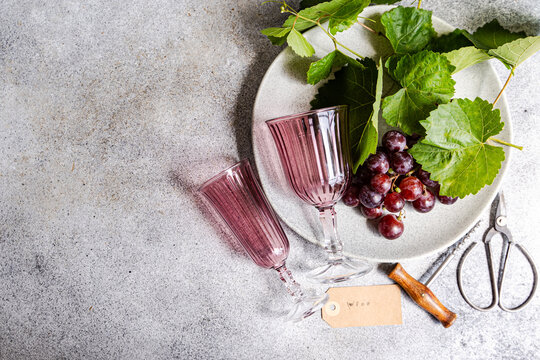 Wine glass and fresh grape still life with garden shears