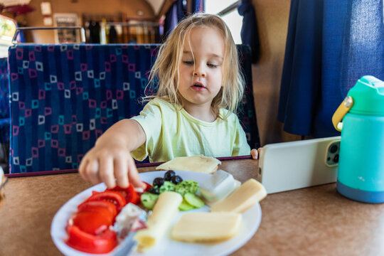 Young girl eat healthy meal on a train journey
