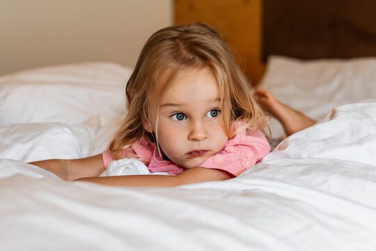 Toddler girl awake in bed during quiet morning