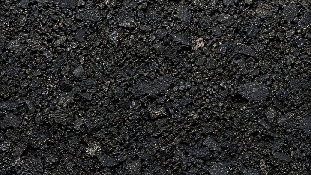 Close up top down view of dark black asphalt road surface texture
