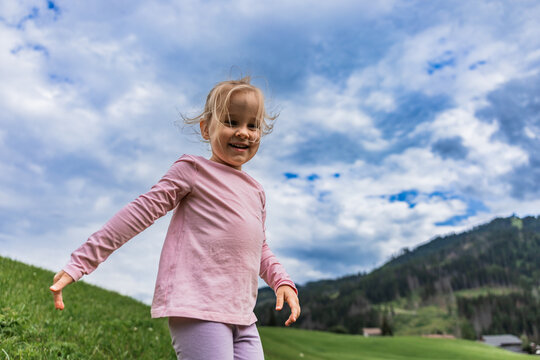 Happy child explore meadow in the Italian Dolomites