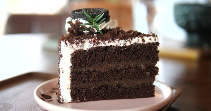 Close up of sliced chocolate fudge cake with oreo cookie and chocolate flakes