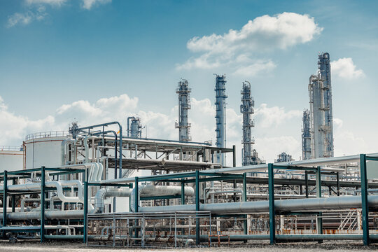 Petroleum Refinery Oil and Gas plant industrial complex building. Petrochemical industry site outdoor exterior with storage tank and pipes.