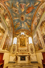 Naklejka premium LUCCA, ITALY - JUNE 23, 2026: The chapell Cappella della Croce the church Basilica di San Frediano with the frescoes by Amico Aspertini (1508 - 1509).