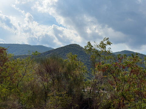 Green mountains beneath dramatic stormy cloudy summer sky