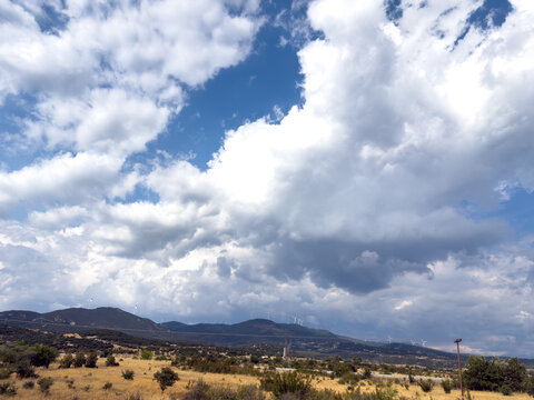 Cloudy blue sky above golden dry countryside landscape