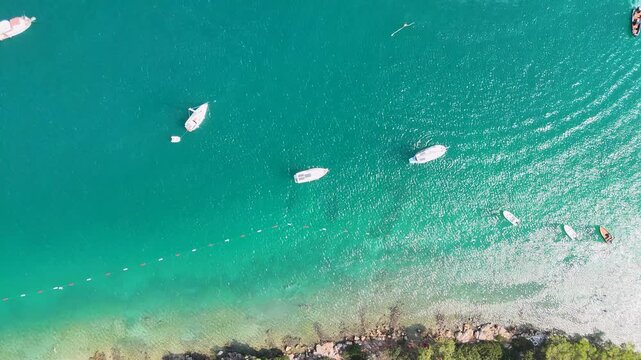 Aerial Drone Flyover Turquoise Bay with Boats Torba Turkey