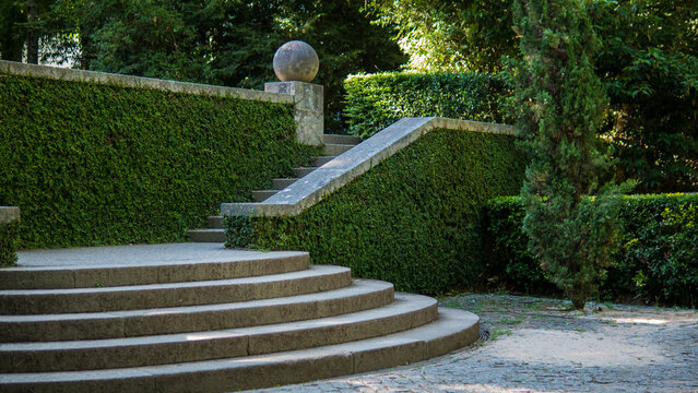 Curved Granite Steps and Stone Sphere Finial Framed by Clipped Ivy Hedges in a Formal Terraced Garden &mdash; Landscape Architecture, Garden Design and Tranquillity Concept