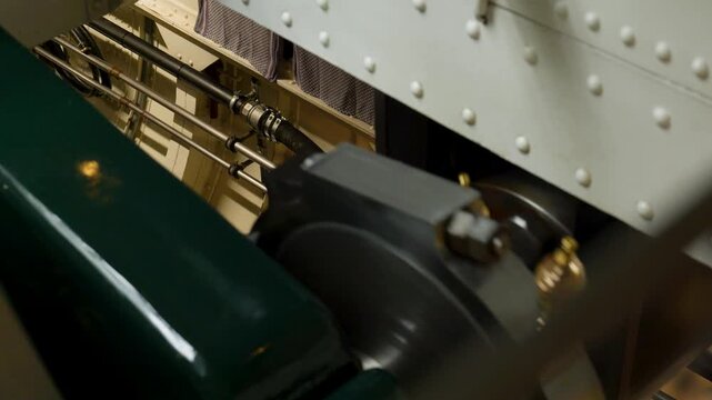 Old steam engine with moving crankshaft, cylinders and valves, showcasing industrial revolution technology. Switzerland