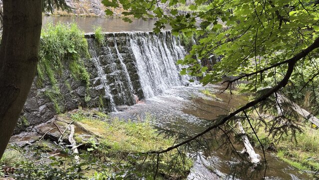 Small waterfall over stone dam