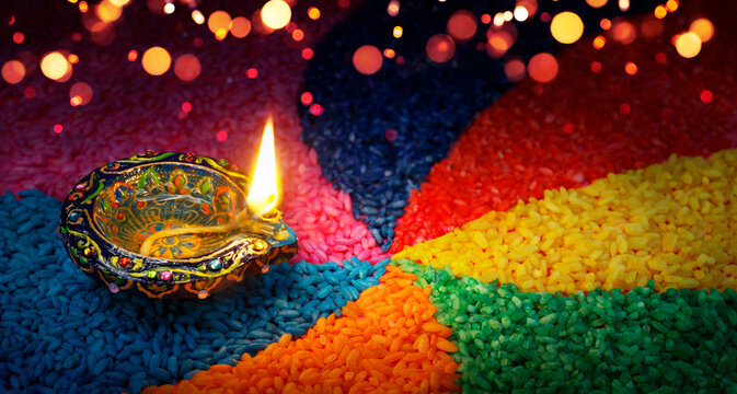 Diwali - Diya With Colorful Rangoli - Oil Lamp With Colored Rice And Bokeh Lights