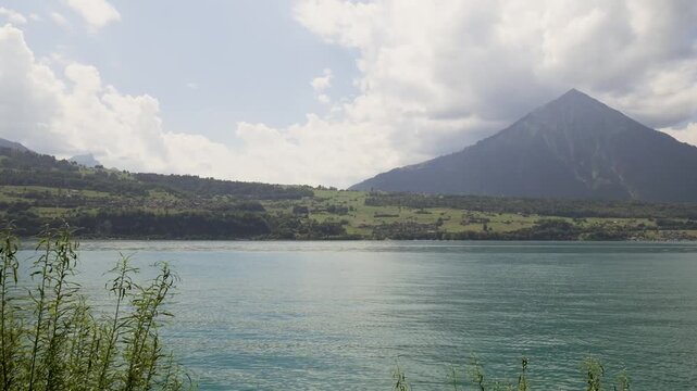 Stunning view of the turquoise waters of lake thun with the niesen mountain in the background. Switzerland