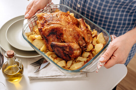 Homemade Roast Chicken With Roasted Potatoes Served At A Family Dinner Table