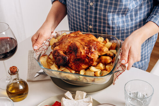 Homemade Roast Chicken With Roasted Potatoes Served At A Family Dinner Table. Roast Chicken or a turkey With Potatoes