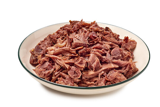 Plate of shredded beef barbacoa in shallow white bowl closeup, with beef, barbacoa, shredded, meat detail, showing bowl, plate, pulled, cooked context, with clear visible detail